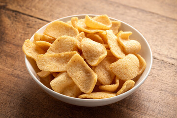Crispy Prawn Crackers in white bowl on wooden table