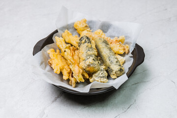 Deep-fried Laver Roll, Deep-fried Squid snack on a black plate
