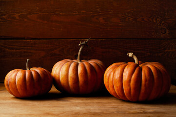 Orange pumpkin on the table, dark wooden background