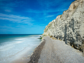 White chalk cliffs of the French Opal Coast and pebble beach facing the English Channel and a...