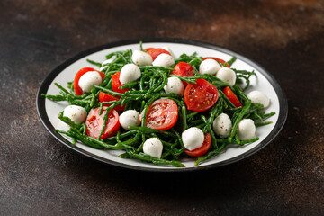 Fresh Samphire salad with cherry tomatoes and mozzarella. Healthy food.
