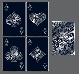 Four aces. Set of vector playing card suits and back design made by floral elements. Vintage stylized illustration in silver colors on black background. Works well as print, icon, emblem, symbol