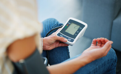 Monitoring my blood-pressure. Cropped shot of a woman checking her blood pressure at home.