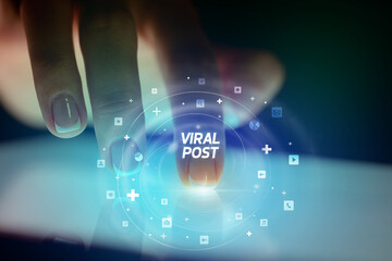 Finger touching tablet with social media icons concept