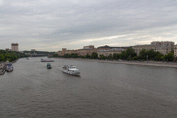 Fototapeta premium MOSCOW, RUSSIA - June 05, 2021: The ships sail along the Moscow river on a cloudy day.