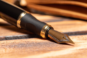 Fountain pen, beautiful fountain pen in an environment with an old clock, old book, ink among...