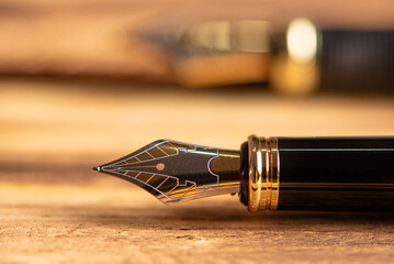Fountain pen, beautiful fountain pen on a rustic wooden surface, selective focus.