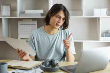 Distance education concept, Teen boy pointing to chart and talking with teacher in class online