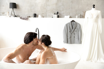Young couple kissing in the bathroom, romantic date. Loving couple together.