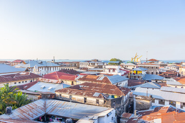 Fototapeta na wymiar Old town of Stone Town, Zanzibar landmark. Panoramic cityscape of Stone Town with rooftops and aerial view. African culture and ethnicity. Travel in Africa. Summer journey in Tanzania. 