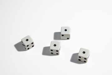 White dice with a one standing close to each other on a white background. Win or lose. Catch your luck. Gambling equipment.