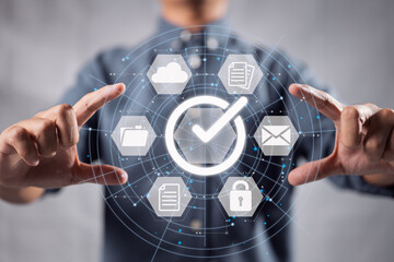 A businessman holds a paper on a digital virtual screen and marks the relevant symbol.
