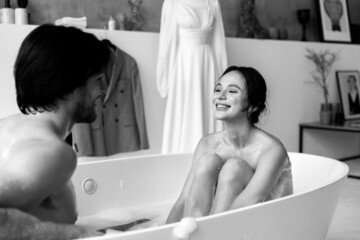 Young cute couple smiling at each other in the bathroom. Black and white photo