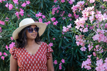 Indian woman travelling and standing next to flowers