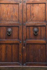 old wooden door with lion door knockers 