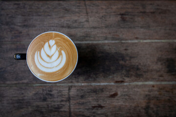 Fototapeta na wymiar latte coffee on wood background