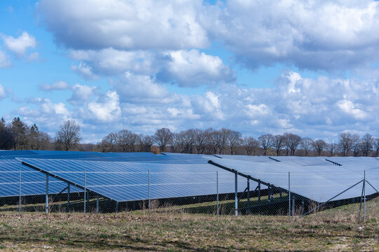 Solar farm on a field with cloudy sky