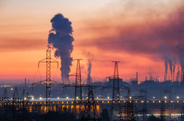 Industrial landscape with electric power lines, hydroelectric dam and metallurgical plants with smoke in the sky, Zaporizhzhia, Ukraine