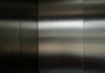 Stainless steel large sheet  With light hitting the surface  For background,Inside passenger elevator,Reflection of light on a shiny metal texture,stainless steel background