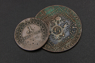Old Austrian copper coin on black background