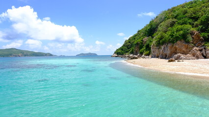 Beautiful tropical beach with white sand and clear water at Kho Kham Island, Chonburi Province, Thailand.