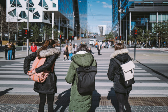 People waiting for the green traffic light in the modern architecture area at Bj&oslash;rvika in Oslo, Norway
