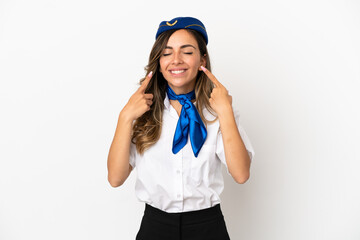 Airplane stewardess over isolated white background smiling with a happy and pleasant expression