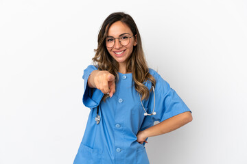 Young surgeon doctor woman over isolated white wall points finger at you with a confident expression