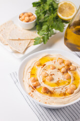 Hummus in a plate with chickpeas, smoked paprika, olive oil and pita. Vegetarian food.