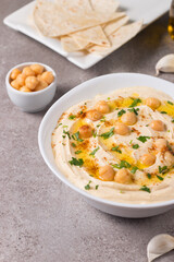 Hummus in a plate with chickpeas, smoked paprika, olive oil and pita. Vegetarian food.