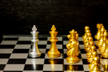 Gold King chess figure and team battle King chess figure on board, team work and management or...