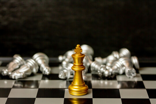 Gold King chess figure win all silver chess figure on board, management or leadership concept.