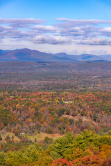 Small white cottage in the middle of colorful fall foliage. New Paltz, New York