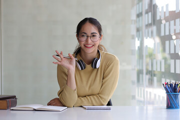 Young woman has a video call with her colleague. Woman blogger teacher sits at home office doing, online job interview during video chat conference call, record vlog teaching on webinar in app, webcam