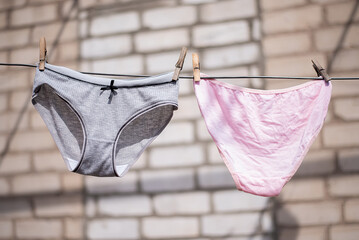 women's panties linen after washing dry on a rope on clothespins