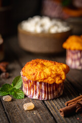Sweet homemade cottage cheese muffins with pumpkin on dark wooden background