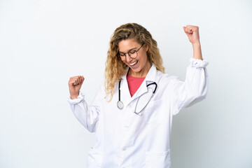 Young doctor blonde woman isolated on white background celebrating a victory