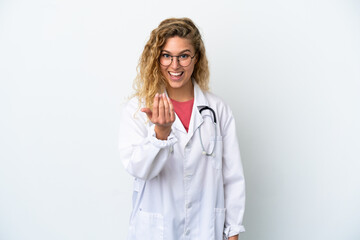 Young doctor blonde woman isolated on white background inviting to come with hand. Happy that you came - obrazy, fototapety, plakaty