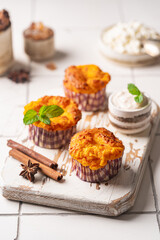 Sweet homemade cottage cheese muffins with pumpkin on white background