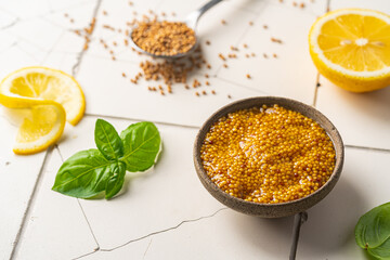 Fresh homemade organic dijon mustard in a bowl on white background, close up
