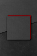 Black and red rectangular mockups on a dark concrete background. Design elements or portfolio. Copy...