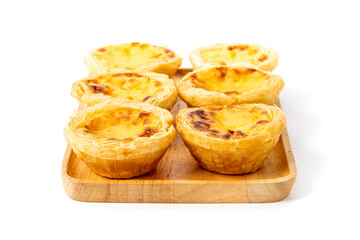 Egg tart on wooden plate isolated on white background