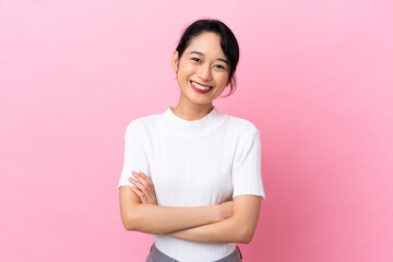 Young Vietnamese woman isolated on pink background keeping the arms crossed in frontal position