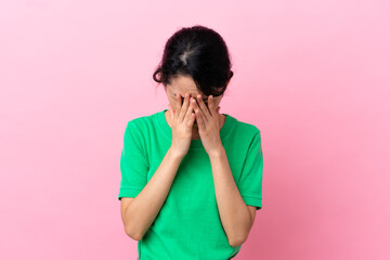 Young Vietnamese woman isolated on pink background with tired and sick expression