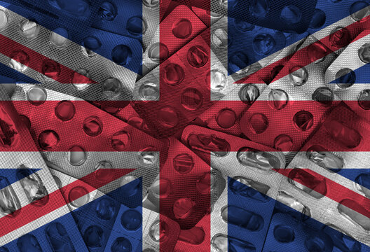 United Kingdom flag and empty packaging of medicine pills in the background. UK flag