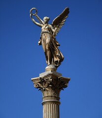 a golden angel statue in Prague 
