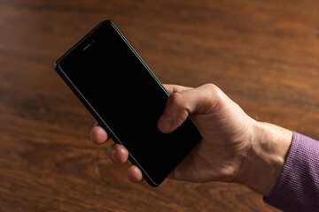 Touch screen smartphone, in hand. close up