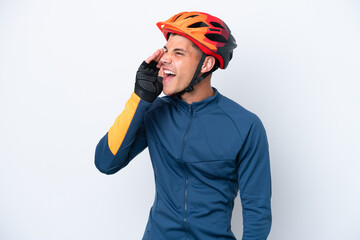 Young cyclist caucasian man isolated on white background shouting with mouth wide open to the side