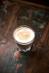 Coffee with milk on rustic wooden background. Soft focus. Close up. Copy space.	                           