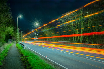 Light trails at urban road created by lights from truck and cars.